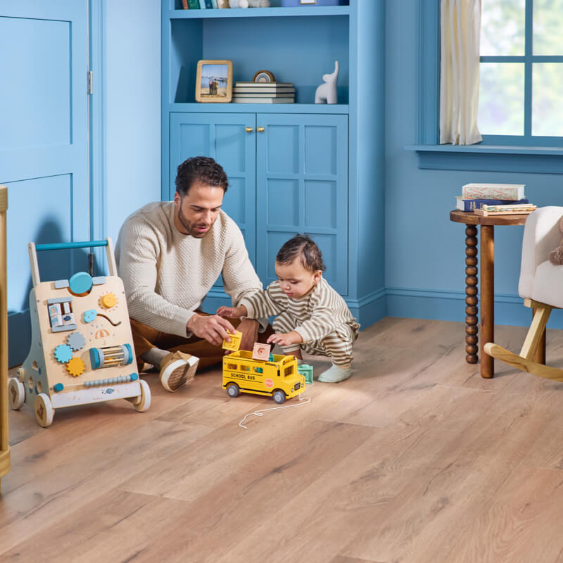 Dad son playing with toys | Yates Flooring